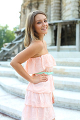 Young beautiful blonde woman in pink dress