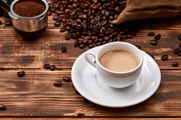 Coffee latte with coffee beans on a wooden table.