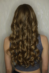 texture of hair, curls on the head of a girl on a white background close-up of beauty salons, curling