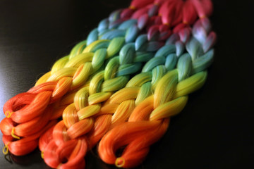 colored thin plaits, many braids, a rainbow, colored hair, blue hair on a girl, a woman's head, color kanekalon