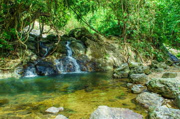 Naklejka na ściany i meble Beautify of medium waterfall around stones and forest at Khao Yai National Park - Nakhon Nayok Province, Thailand. For travel, landscape.