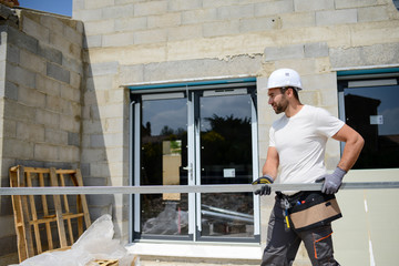 portrait of handsome construction worker on building industry construction site