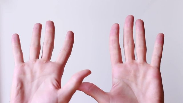 Male hands waving overhead