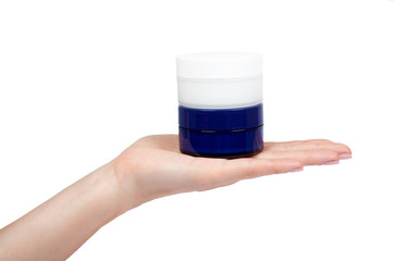 Clean cream bottle with hand isolated on white background