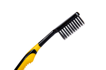Black and yellow soft toothbrush isolated on white background