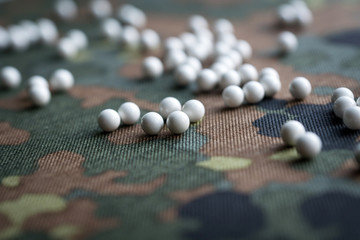 airsoft balls on the background of camouflage fabric