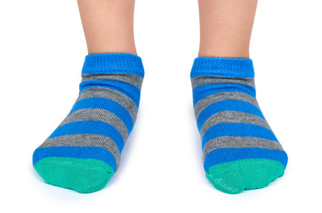 Kid legs in striped socks isolated on white background