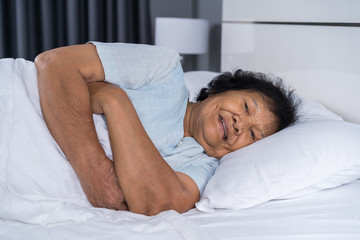 Fototapeta na wymiar happy senior woman sleeping on bed