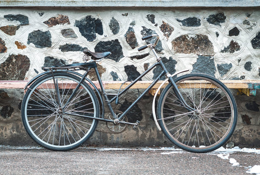 Vintage bicycle on the stone wall background