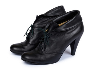 Female black leather high heel shoes isolated on white background