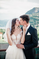 wedding couple kissing on the background of the mountains