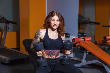 Fototapeta na wymiar girl with tattoos on fitness