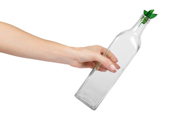 Empty transparent glass oil dispenser with hand isolated on white background