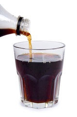 Cola drink in glass flow from bottle, isolated on white background