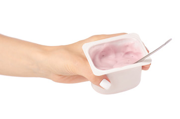 Yogurt with a spoon in hand on a white background isolation