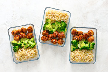 Asian style chicken meat balls with broccoli and rice in a take away lunch boxes