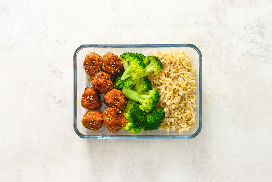 Asian style chicken meat balls with broccoli and rice in a take away lunch box