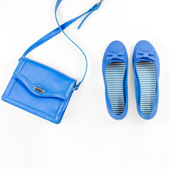 Female summer fashion accessories flat lay with blue flats and purse