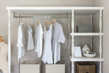white color shirts hanging on rail