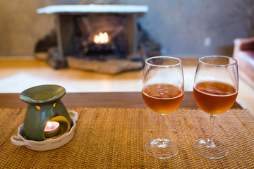 Beer glasses with aroma lamp romantic time at fireplace