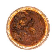 Open jar of sprats in a tomato sauce isolated on a white background.