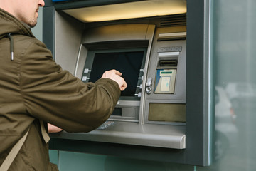 The tourist withdraws money from the ATM for further travel. Finance, credit card, withdrawal of...