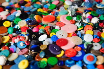 Lot of colorful plastic clothing buttons. Many small round vintage buttons pattern background