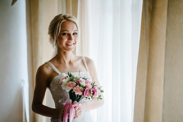 Young attractive bride with flowers.