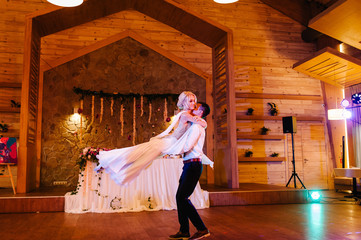 First wedding dance of newlywed. bride and groom dancing in restaurant.