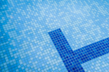 Part of the pool. Underwater turquoise texture. Blue water clear, bottom pool. The lines separating the pool for swimming lanes. Pool for children and adults. View in the water.