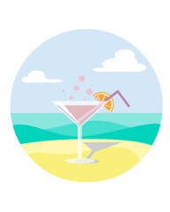 martini on sand with an orange slice on the beach