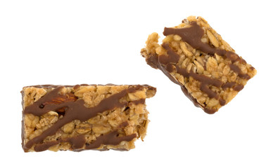  Top view of a chocolate with nuts granola bar broken in half isolated on a white background.