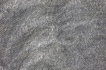 Close view of a gray shirt with liquid cleaner spray.