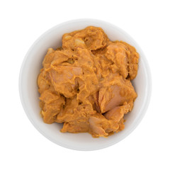 Top view of a bowl of curry flavored tuna isolated on a white background.