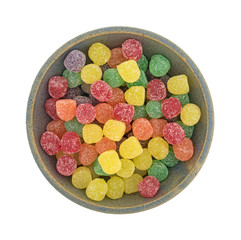 Top view of sugar coated gummy candy in a bowl isolated on a white background.
