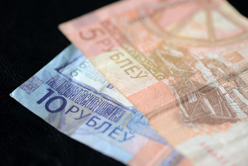 Two Belarusian banknotes on a dark background close up
