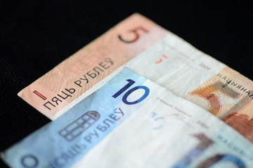 Two Belarusian banknotes on a dark background close up