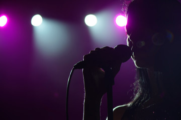 close up image of live singer on stage - Powered by Adobe