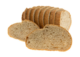 Small loaf of bread with two slices in front isolated on a white background.