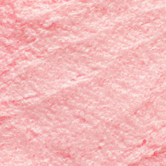 Texture cosmetic scrub for face and body pink sugar. Selective focus, trendy punchy pastel background