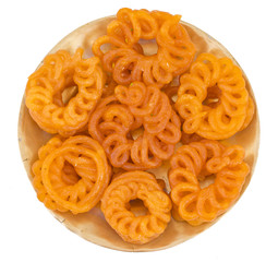 Indian Sweet Food Imarti Also Know as Amriti, Omriti, Jahangir, Jalebi, Jaangiri. It is Mde by Deep-Frying Vigna Mungo Flour Batter in a Kind of Circular Flower Shape. isolated on white Background