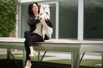 pretty brunette woman with Pomeranian dog