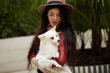 pretty brunette woman with Pomeranian dog