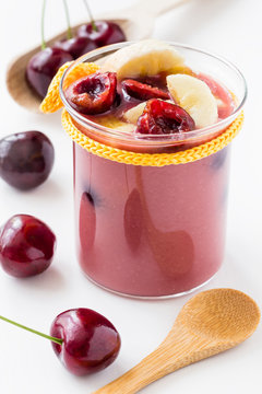 Smoothie de cereza y pl&aacute;tano sobre fondo blaco