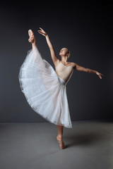 Beautiful patient lady is engaging in ballet and stretching.