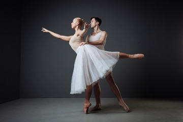 Pair of young cute dancers training and doing support.