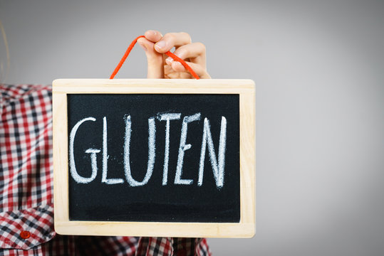 Woman holding board with gluten sign