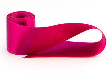 A satin ribbon of lilac color twisted into a roll with one turn of the edge of a ribbon on a white...