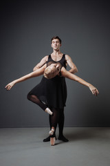 Two young cute dancers moving graceful and man supporting ballerina.