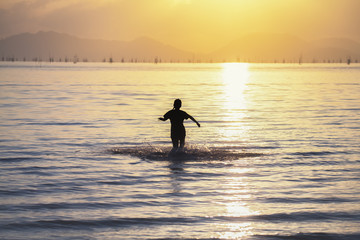 Children are running into the sea.